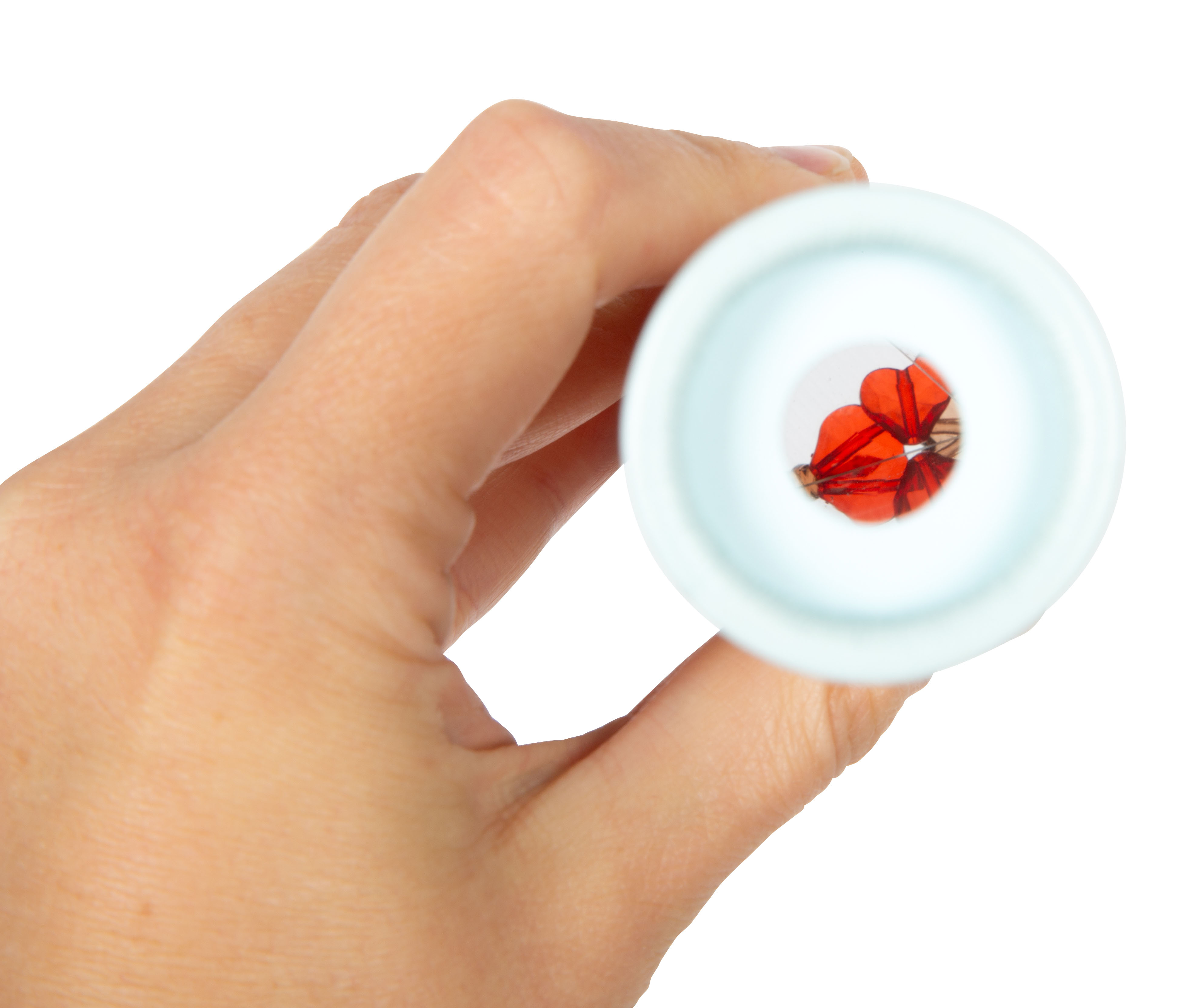 Hand hält Kaleidoskop für Kinder